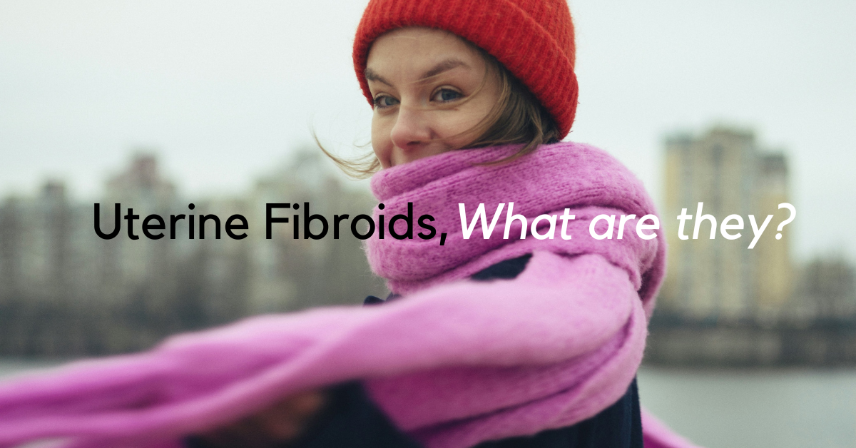 women wearing pink scarf, looking at camera. writing says:? uterine fibroids, what are they?